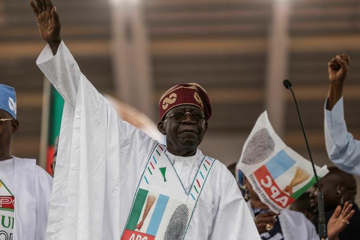 Bola Tinubu gestures toward the crowd during a campaign rally in Lagos. He has been declared the winner of Nigeria's presidential elections.