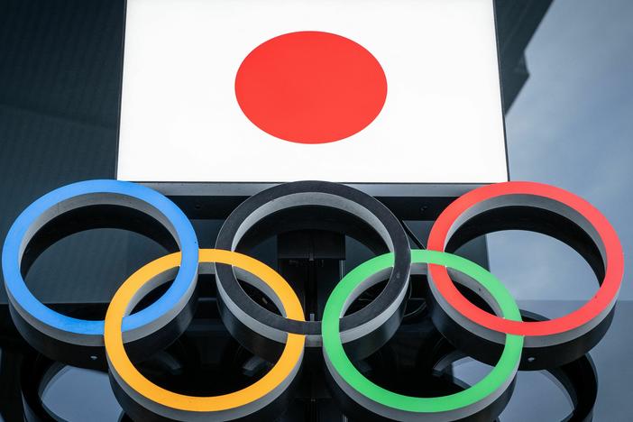 The Japanese flag and Olympic rings are seen at the Japan Olympic Museum near the National Stadium in Tokyo on Feb. 17.