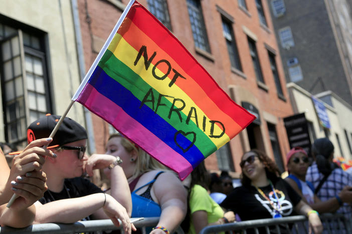 In this June 26, 2016, file photo, a woman holds a rainbow flag during the NYC Pride Parade in New York.