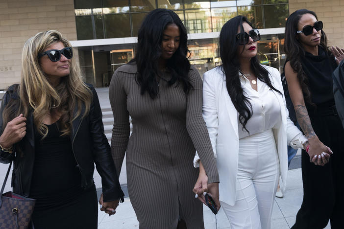 Vanessa Bryant, center, Kobe Bryant's widow, leaves a federal courthouse with her daughter Natalia and soccer player Sydney Leroux in Los Angeles, Aug. 24, 2022.