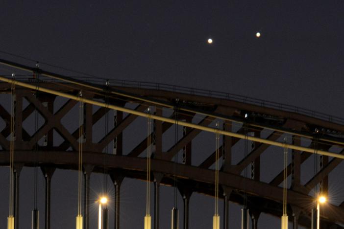 Venus and Jupiter, in a rare conjunction, seem close even though they are 400 million miles apart.