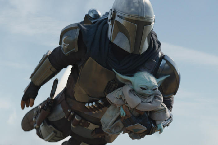 The Mandalorian (Pedro Pascal) and Grogu in Season 2 of <em>The Mandalorian.</em>