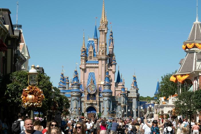 Visitors walk along Main Street at Walt Disney World's Magic Kingdom in September 2022. Last week, Florida Gov. Ron DeSantis signed a bill to move Disney World's special tax district under quasi-government control.