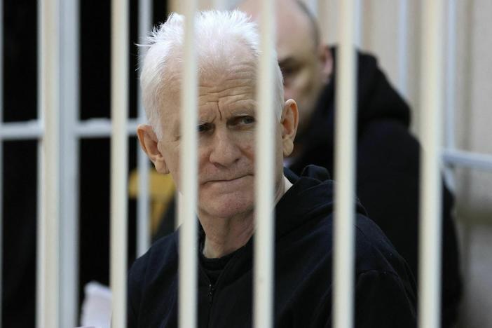 Nobel Prize winner Ales Bialiatski is seen in the defendants' cage in the courtroom at the start of the hearing in Minsk on Jan. 5, 2023