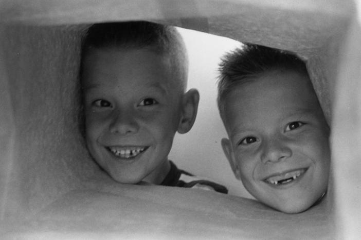 Circa 1955: Bobby, whose two front teeth dropped out recently, with his twin brother Jerry.