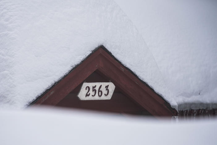 Snow is piled up on a home in Running Springs, Calif., on Feb. 28, 2023. Mountainous areas of California experienced nearly unprecedented snowfall accumulations — more than 40 feet since the start of the season.