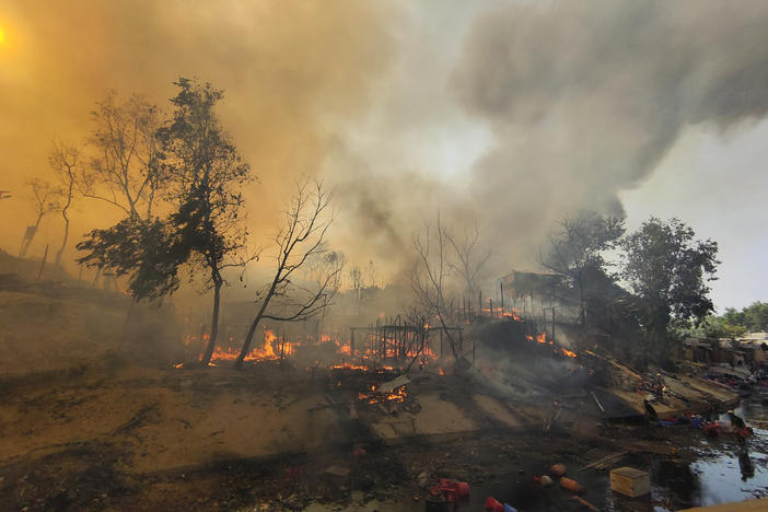 Rohingya refugees try to salvage their belongings after a major fire in their Balukhali camp at Ukhiya in Cox's Bazar district, Bangladesh, on March 5, 2023.