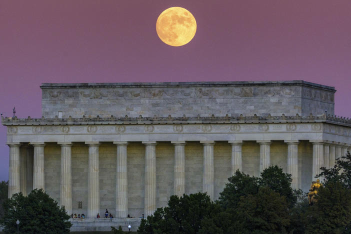 The full moon, also called the Beaver Moon, rises above the Lincoln Memorial at sunset in Washington, Monday, Nov. 7, 2022.