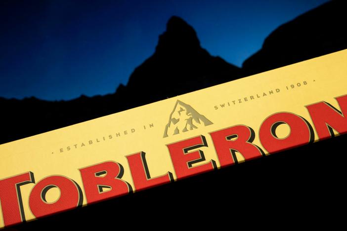 A Toblerone chocolate bar, pictured with the Matterhorn in the background. The company will replace the iconic peak on its label with a more generic mountain as a result of manufacturing changes.