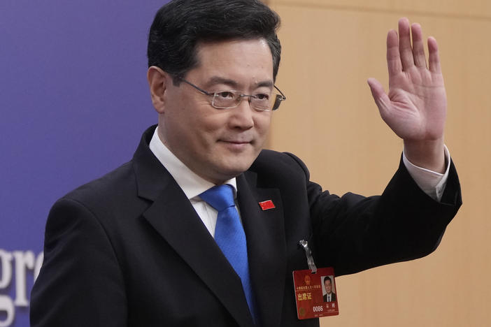 Chinese Foreign Minister Qin Gang waves as he arrives for a press conference held on the sidelines of the annual meeting of China's National People's Congress (NPC) in Beijing, Tuesday, March 7, 2023.