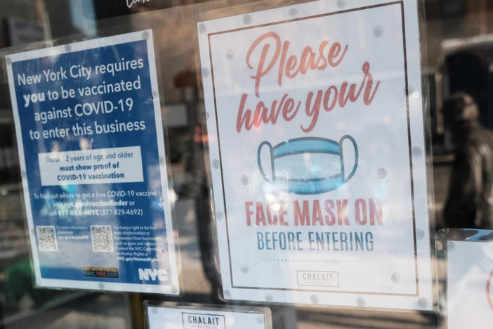 New York no longer has a face mask mandate — and New York City Mayor Eric Adams is telling stores to get customers to lower their mask before entering, to help prevent crime. It's a reversal of previous guidance for shops: Here, a face mask sign is seen on a cafe's door in December of 2021, when the state mandated the wearing of masks.