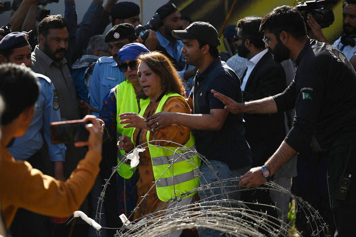 Policemen try to stop activists during a rally to mark International Women's Day in Islamabad on March 8 — and demand equal rights for women in Pakistan. Thousands of women took part in rallies across the country despite efforts by authorities in several cities to block the marches.