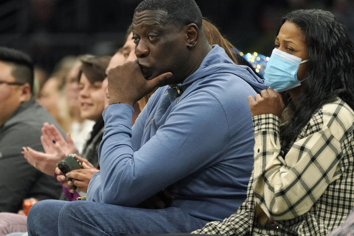Former Seattle SuperSonics forward Shawn Kemp (center) was booked into jail Wednesday, on a felony charge stemming from a shooting. He's seen here last year, at a WNBA game between the Seattle Storm and the Chicago Sky.