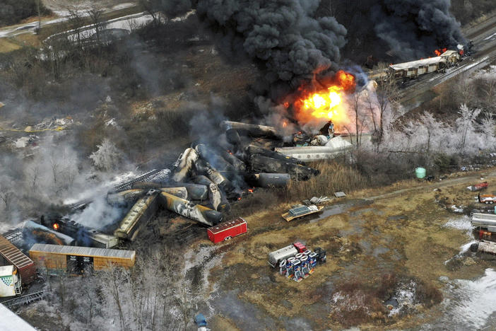 Portions of a Norfolk Southern freight train that derailed in East Palestine, Ohio on Feb. 3 remained on fire the next day.