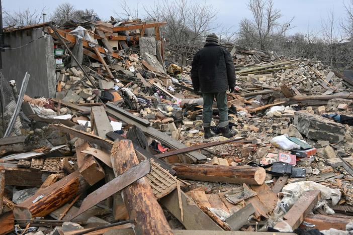 People search the rubble of a house following a Russian strike in the village of Velyka Vilshanytsia, near the city of Lviv in Western Ukraine, on Thursday.