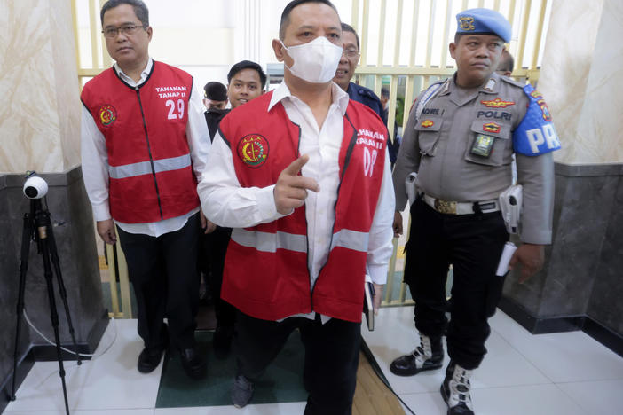 Arema FC Organizing Committee chair Abdul Haris, left, the club's security chief Suko Sutrisno, center, walk to the courtroom to attend their sentencing hearing at a district court in Surabaya, East Java, Indonesia, Thursday, March 9, 2023.