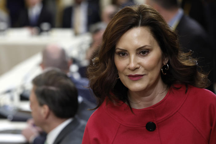 Michigan Gov. Gretchen Whitmer walks to her seat at a meeting between President Biden and governors from around the country at the White House on Friday. Whitmer and Biden were both mentioned in alleged threats made by a Michigan man arrested on firearms charges.