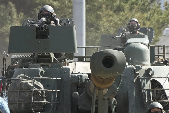 South Korean army soldiers ride K-5 self-propelled howitzers in Yeoncheon, South Korea, near the border with North Korea, Monday, March 13, 2023.