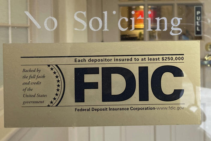 An FDIC sign is posted on a window at a Silicon Valley Bank branch in Wellesley, Mass., on Saturday. The bank was caught in a meltdown, forcing a government takeover. The FDIC guarantees accounts up to $250,000.