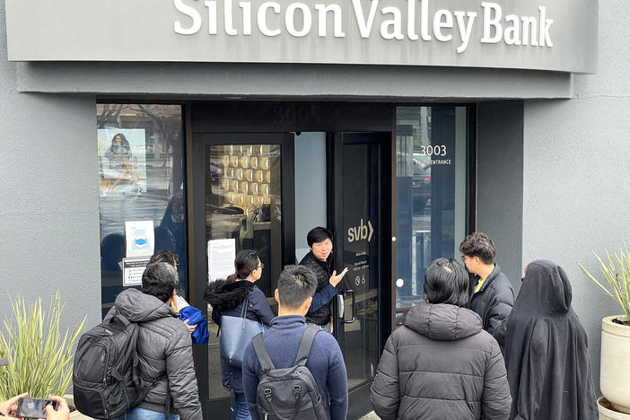 SANTA CLARA, CALIFORNIA - MARCH 10: A worker (C) tells people that the Silicon Valley Bank (SVB) headquarters is closed on March 10, 2023 in Santa Clara, California.