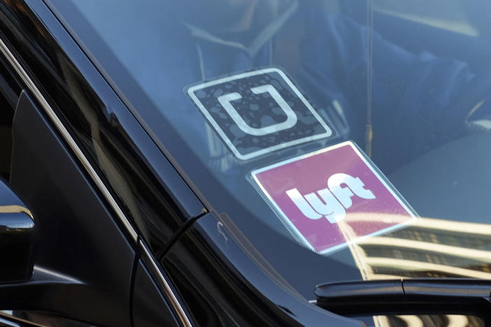 In this Jan. 12, 2016, file photo, a ride share car displays Lyft and Uber stickers on its front windshield in downtown Los Angeles. A California appeals court ruled March 13, 2023, that a voter-backed initiative exempting Uber and Lyft from a key provision of state employment law is constitutional, a reversal of a lower court decision that marks a win for the ride-hailing giants.