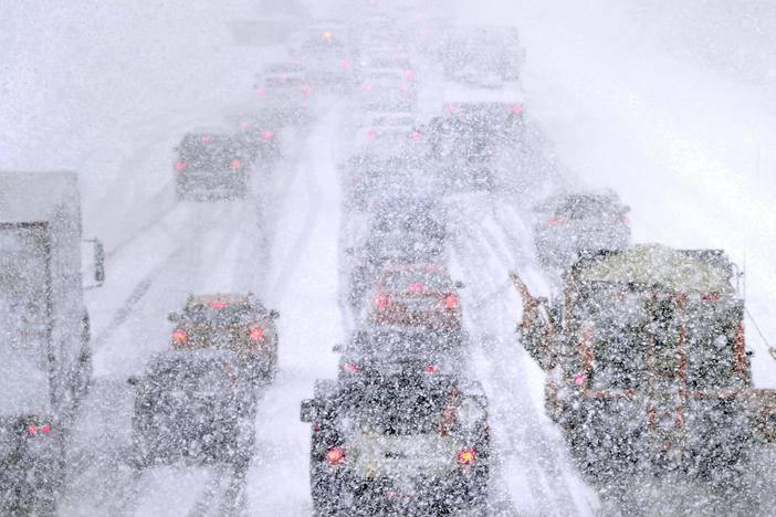 Plows, at right, try to pass crawling traffic in the snow on Route 93 South in Londonderry, N.H., Tuesday. The storm is expected to continue into early Wednesday.
