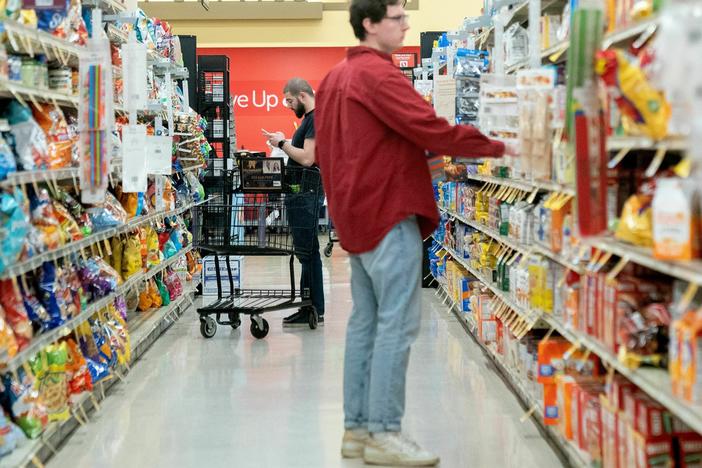Shoppers browse at a grocery store in Washington, D.C. Retail sales dipped in February after surging in the previous month.