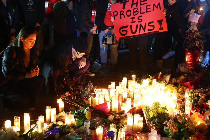 People attend a candlelight vigil for victims of a deadly mass shooting on Jan. 24 in Monterey Park, Calif. President Biden will announce his latest gun safety push there on Tuesday.