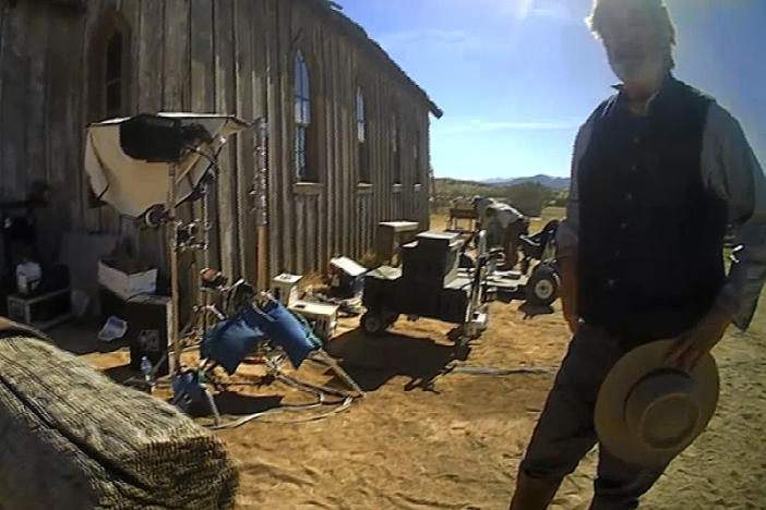 In this 2022 image from video released by the Santa Fe County Sheriff's Office, Alec Baldwin stands in costume and speaks with investigators following a fatal shooting on a movie set in Santa Fe, N.M.