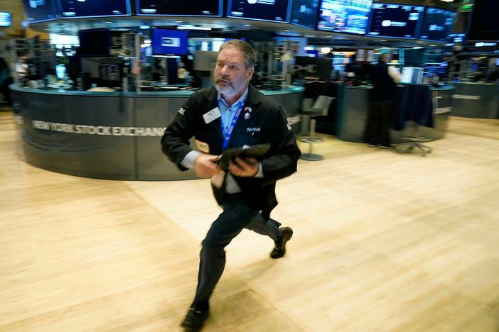 Traders work on the floor of the New York Stock Exchange in New York City on Tuesday. Stocks tumbled on Wednesday amid fears that worries about the banking system were widening to other parts of the world.