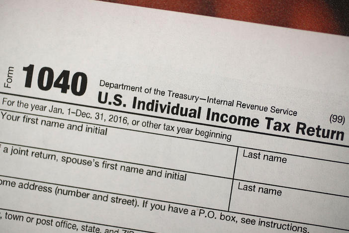 A copy of a IRS 1040 tax form is seen at an H&R Block office on the day President Donald Trump signed the Republican tax cut bill in Washington, DC on December 22, 2017 in Miami, Florida.
