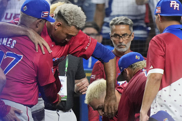 Puerto Rico pitcher Edwin Díaz is helped into a wheelchair after he appeared to injure himself during a postgame celebration after Puerto Rico beat the Dominican Republic 5-2 during a World Baseball Classic game on Wednesday in Miami.