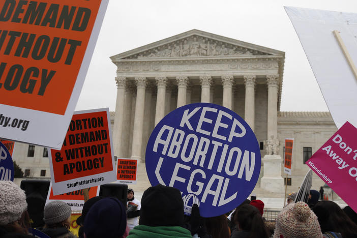 Pro-abortion rights signs are seen during the March for Life 2016 in front of the U.S. Supreme Court in Washington, on Jan. 22, 2016. The North Dakota Supreme Court ruled Thursday that a state abortion ban will remain blocked while a lawsuit over its constitutionality proceeds.