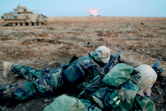 Soldiers of the U.S. Army 3rd Infantry Division secure a field near Najaf, Iraq, at sunrise on March 23, 2003.