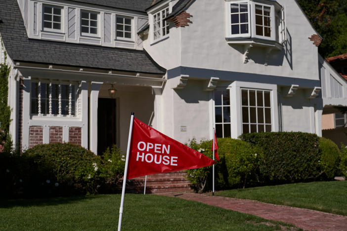 An 'open house' flag is displayed outside a single family home on September 22, 2022 in Los Angeles, California. The U.S. housing market is seeing a slow down in home sales due to the Federal Reserve raising mortgage interest rates to help fight inflation.