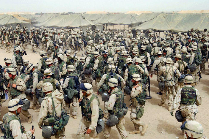 March 20, 2003: U.S. Marines prepare themselves after receiving orders to cross the Iraqi border at Camp Shoup, in northern Kuwait.