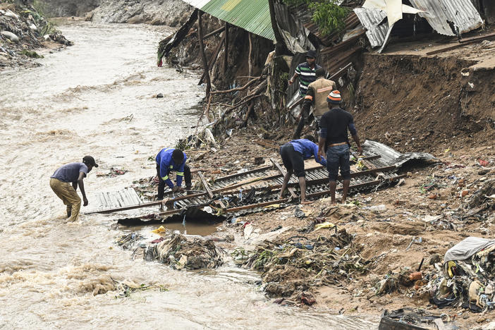 Residents in southern Malawi repair a home destroyed by heavy rain from Cyclone Freddy. Climate change is causing cyclones and hurricanes to get more intense and dangerous.