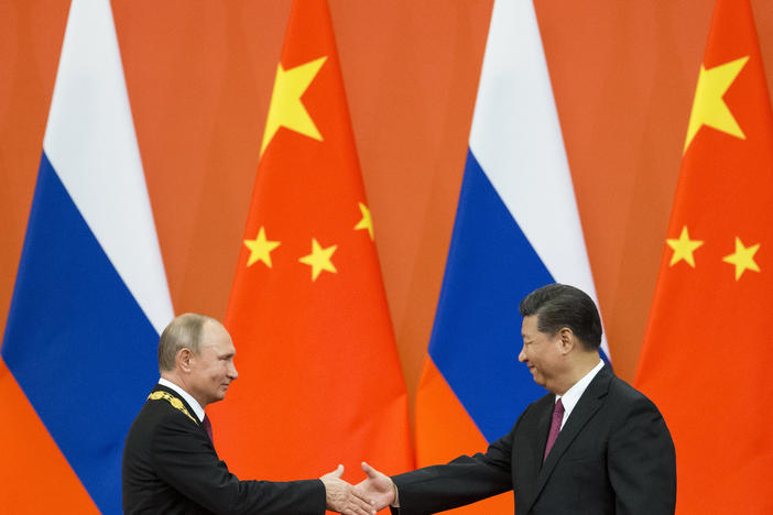 Chinese President Xi Jinping, right, and Russian President Vladimir Putin shake hands during an awarding ceremony at the Great Hall of the People in Beijing, China, on June 8, 2018. Xi is traveling to Moscow to show support for Putin.