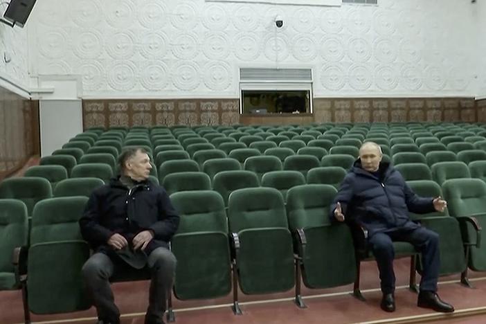 In this photo taken from video released by Russian TV Pool on Sunday, March 19, 2023, Russian President Vladimir Putin gestures while speaking to Russian Deputy Prime Minister Marat Khusnullin, left, at the Mariupol theater during his visit to Mariupol in Russian-controlled Donetsk region, Ukraine.