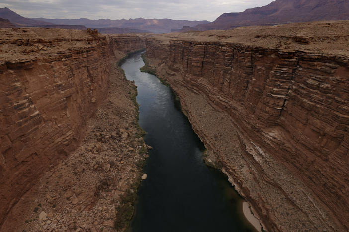 The Colorado River flows by the historic Navajo Bridge on June 23, 2021 in Marble Canyon, Ariz.
