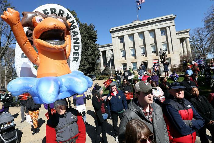 Demonstrators gather outside the North Carolina State Capitol in Raleigh, N.C., with a "FLUSH GERRYMANDER" inflatable on the day the state's highest court held a rehearing for the redistricting case known nationally as <em>Moore v. Harper</em>.
