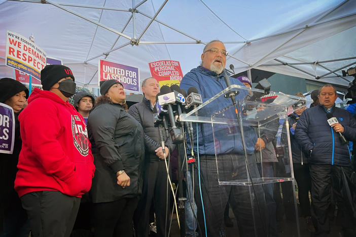 Max Arias, Executive Director of the SEIU Local 99 union speaks to members of the press and community at a demonstration outside of Robert F. Kennedy Community School in Koreatown. Behind him is Cecily Myart-Cruz, the president of the UTLA teachers union, and U.S. Rep. Adam Schiff (D-CA).