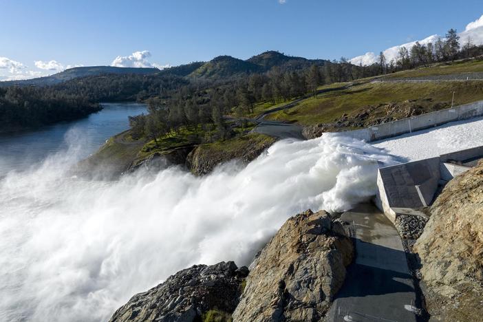 Water pours out of Lake Oroville in Northern California in March. Reservoirs levels plummeted over the last three years, but now have more water than they can hold.