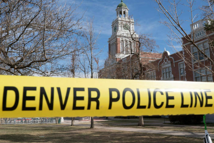 Police tape surrounds East High School following reports of a shooting that left two people injured on Wednesday.