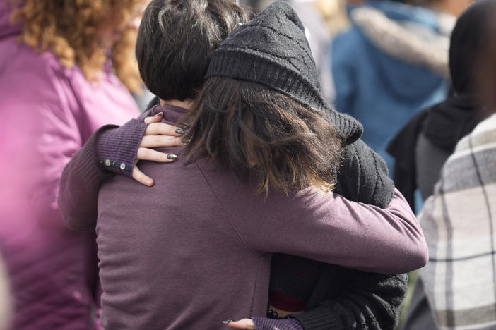 A parent hugs a student as they are reunited after a school shooting at East High School Wednesday, March 22, 2023, in Denver. Two school administrators were shot at the high school Wednesday morning after a handgun was found on a student subjected to daily searches, authorities said.