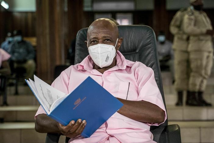 Paul Rusesabagina looks on as he sits with some of his co-accused at the Supreme Court in Kigali, Rwanda, on Feb. 17, 2021, where he denied charges of being associated with an armed group. On Friday, the Rwandan government said it commuted his sentence.