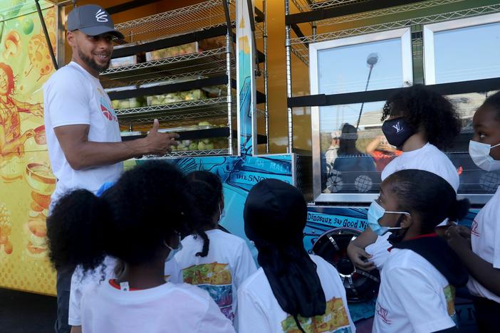 In this 2021 file photo, NBA star Steph Curry talks to kids in Oakland, Calif., about nutrition and exercise.