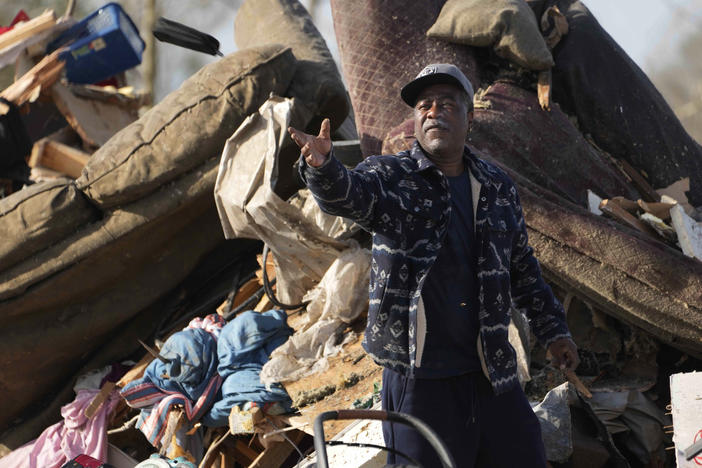 A resident looks through piles of debris, insulation and home furnishings to see if anything is salvageable at a mobile home park in Rolling Fork, Miss., on Saturday.