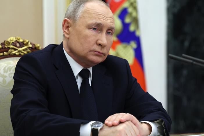 Russian President Vladimir Putin listens to Russian Transport Minister Vitaly Savelyev during a meeting in Moscow on Saturday.