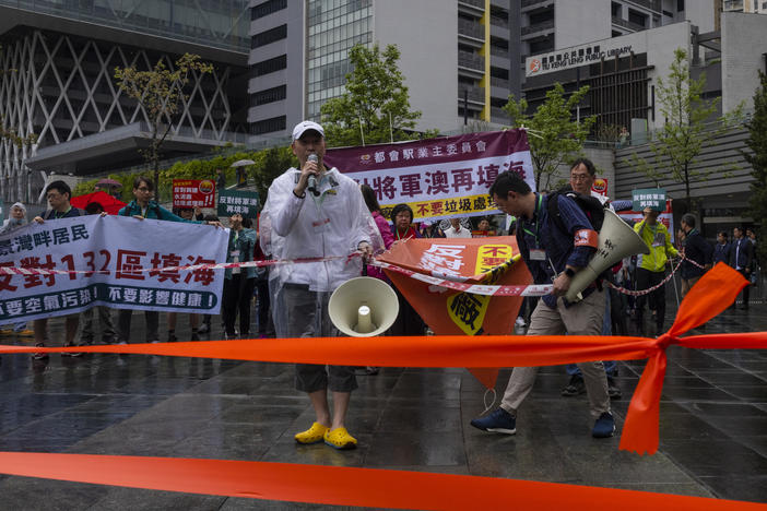 Protesters wearing number tags during a rally in Hong Kong, Sunday. Dozens of people on Sunday joined Hong Kong's first authorized demonstration against the government since the lifting of major COVID-19 restrictions under unprecedentedly strict rules, including wearing a numbered badge around their necks.